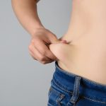 women with overweight show fat on the stomach